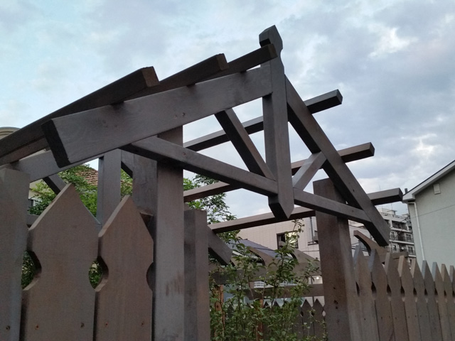 木製フェンスの入口の上はおしゃれなパーゴラ